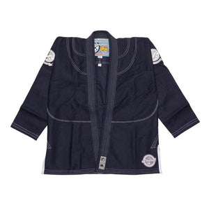 Shoyoroll Batch #8: The Yank, a navy blue Jiu-Jitsu gi featuring a lightweight 450 GSM pearl weave jacket and 12 oz ripstop cotton pants, part of the East vs. West series inspired by baseball legend 'The Great Bambino.' Includes contrast stitching, a foam collar, stretchy drawstring, ID/iPod pocket, and custom inner taping.