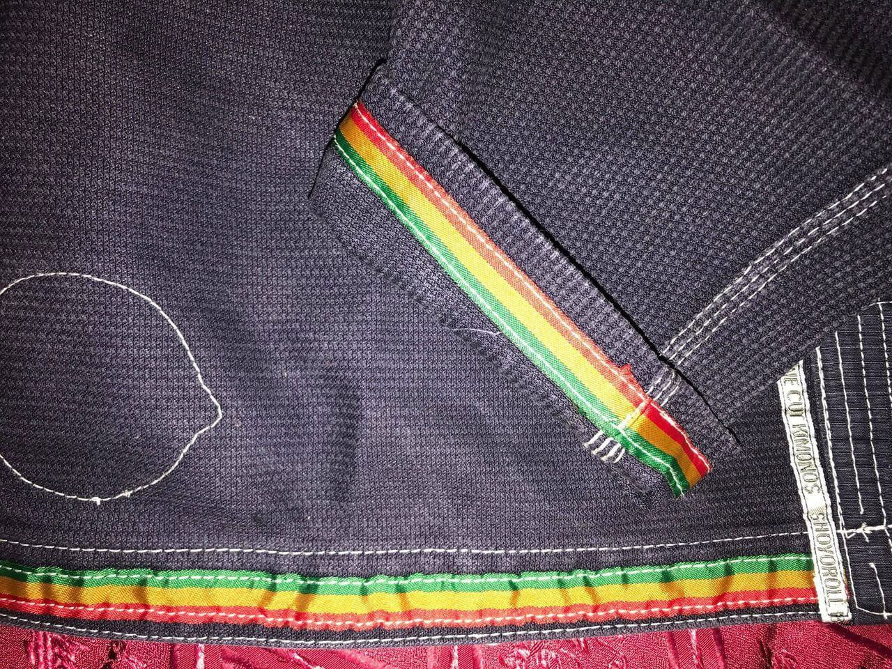 Shoyoroll Batch #8: The Yank, a navy blue Jiu-Jitsu gi featuring a lightweight 450 GSM pearl weave jacket and 12 oz ripstop cotton pants, part of the East vs. West series inspired by baseball legend 'The Great Bambino.' Includes contrast stitching, a foam collar, stretchy drawstring, ID/iPod pocket, and custom inner taping.