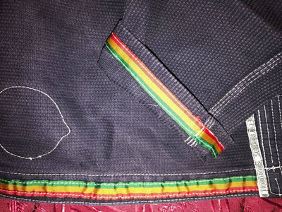 Shoyoroll Batch #8: The Yank, a navy blue Jiu-Jitsu gi featuring a lightweight 450 GSM pearl weave jacket and 12 oz ripstop cotton pants, part of the East vs. West series inspired by baseball legend 'The Great Bambino.' Includes contrast stitching, a foam collar, stretchy drawstring, ID/iPod pocket, and custom inner taping.