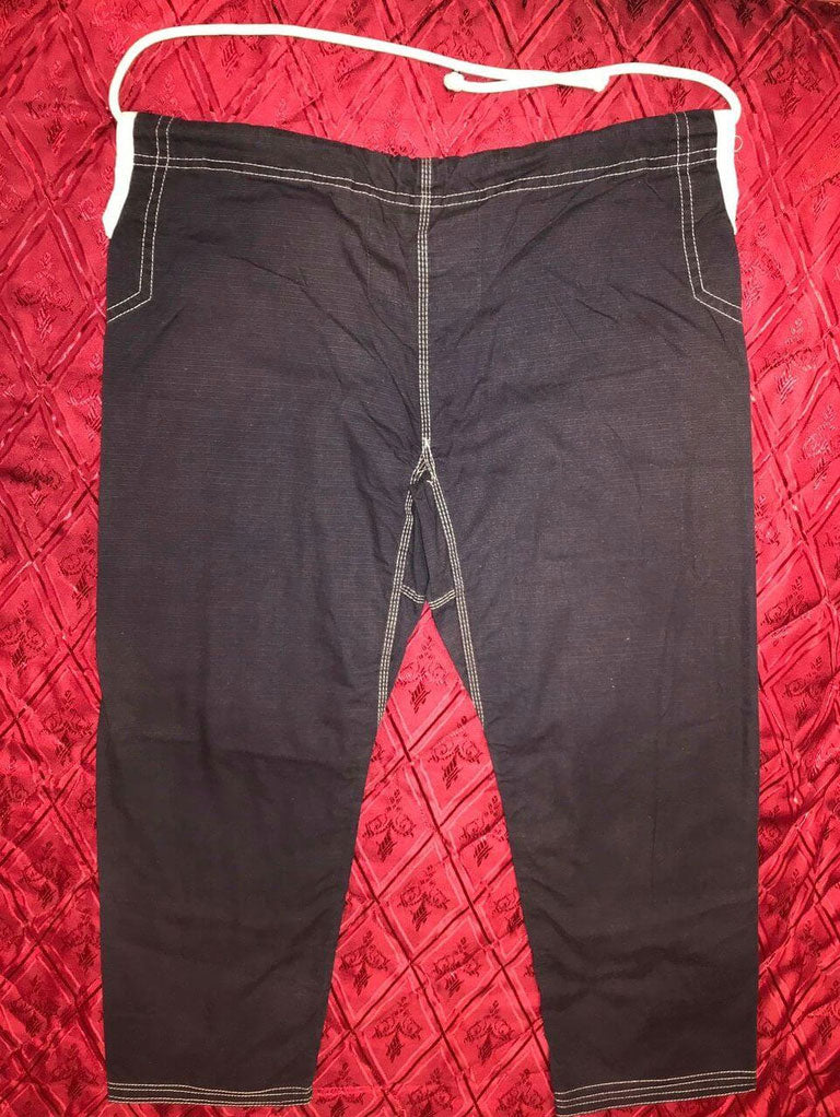 Shoyoroll Batch #8: The Yank, a navy blue Jiu-Jitsu gi featuring a lightweight 450 GSM pearl weave jacket and 12 oz ripstop cotton pants, part of the East vs. West series inspired by baseball legend 'The Great Bambino.' Includes contrast stitching, a foam collar, stretchy drawstring, ID/iPod pocket, and custom inner taping.