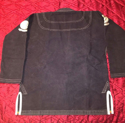 Shoyoroll Batch #8: The Yank, a navy blue Jiu-Jitsu gi featuring a lightweight 450 GSM pearl weave jacket and 12 oz ripstop cotton pants, part of the East vs. West series inspired by baseball legend 'The Great Bambino.' Includes contrast stitching, a foam collar, stretchy drawstring, ID/iPod pocket, and custom inner taping.