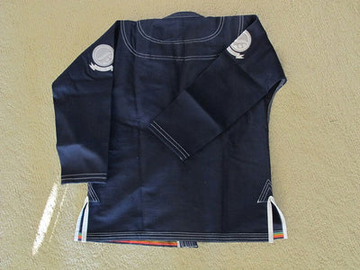 Shoyoroll Batch #8: The Yank, a navy blue Jiu-Jitsu gi featuring a lightweight 450 GSM pearl weave jacket and 12 oz ripstop cotton pants, part of the East vs. West series inspired by baseball legend 'The Great Bambino.' Includes contrast stitching, a foam collar, stretchy drawstring, ID/iPod pocket, and custom inner taping.