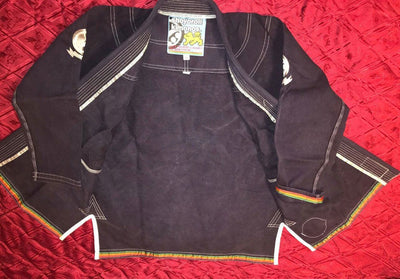Shoyoroll Batch #8: The Yank, a navy blue Jiu-Jitsu gi featuring a lightweight 450 GSM pearl weave jacket and 12 oz ripstop cotton pants, part of the East vs. West series inspired by baseball legend 'The Great Bambino.' Includes contrast stitching, a foam collar, stretchy drawstring, ID/iPod pocket, and custom inner taping.
