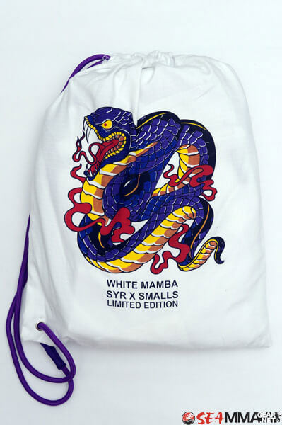Shoyoroll Batch #8 White Mamba Gi, featuring a lightweight 450 GSM pearl weave jacket and 12 oz ripstop pants. Designed by artist John Smalls, this gi showcases a white base with purple trim. Released as part of the East vs. West Series on December 22, 2010, at 3:00 PM PST.