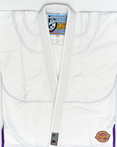Shoyoroll Batch #8 White Mamba Gi, featuring a lightweight 450 GSM pearl weave jacket and 12 oz ripstop pants. Designed by artist John Smalls, this gi showcases a white base with purple trim. Released as part of the East vs. West Series on December 22, 2010, at 3:00 PM PST.